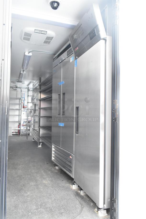Unbranded 2021 fully outfitted cold food and beverage trailer interior with Turbo Air coolers, shelving, and commercial equipment.