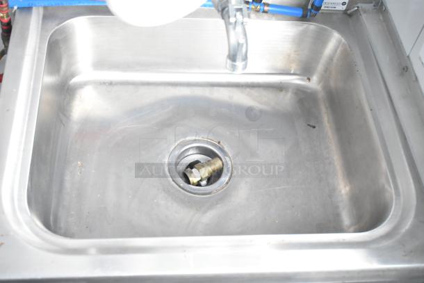 Stainless steel sink with faucet in a fully outfitted retail trailer kitchen. Ideal for cold food and beverage service.