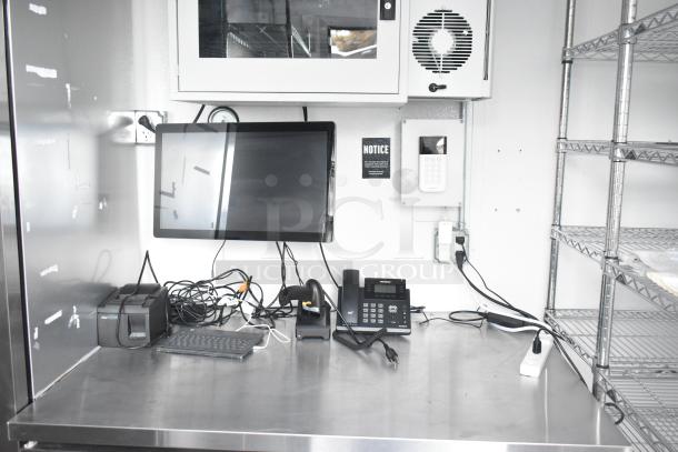 Fully outfitted cold food and beverage trailer interior with POS system, phone, shelves, and stainless steel work surface. New condition.