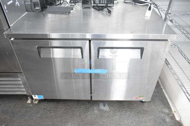 Stainless steel commercial-grade cooler with two doors and Turbo Air logo. Ideal for cold food and beverage storage. New condition.