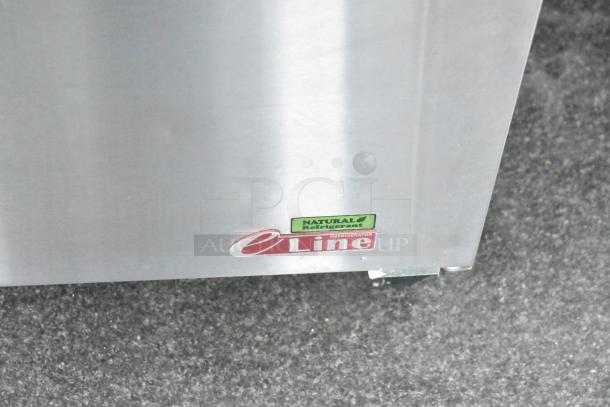 Close-up of a stainless-steel refrigerator corner, with visible "eLine" and "Natural Refrigerant" labels.