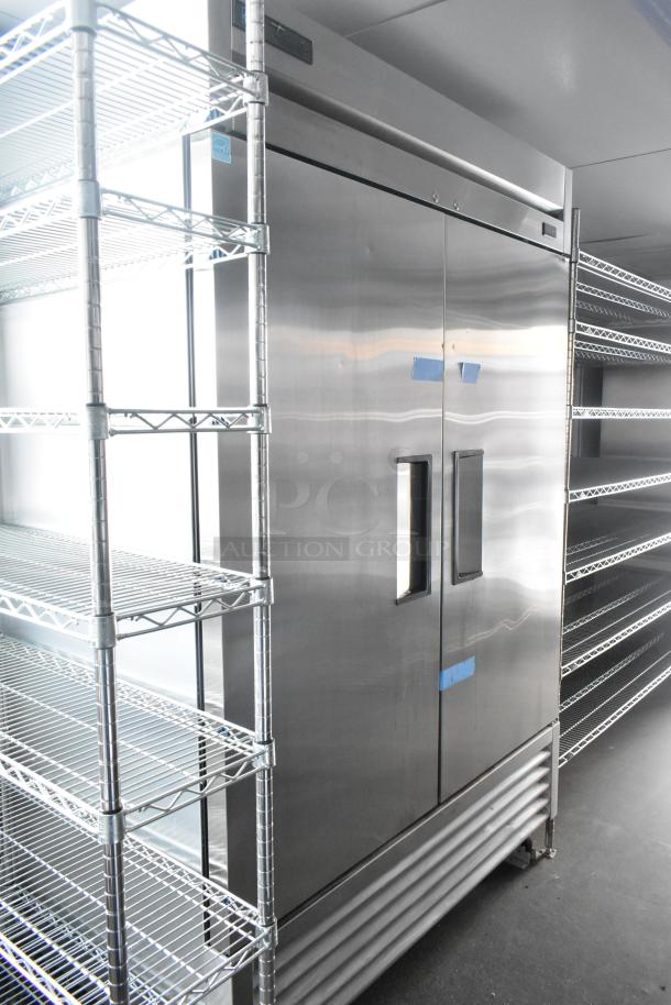 Unbranded retail trailer interior with stainless steel Turbo Air cooler, wire shelving, and flexible storage layout.