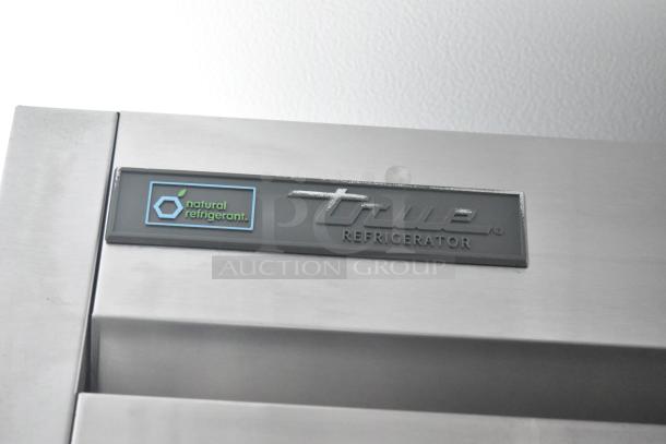 True Refrigerator label on commercial-grade cooler, featuring natural refrigerant logo. Key equipment in cold food trailer.