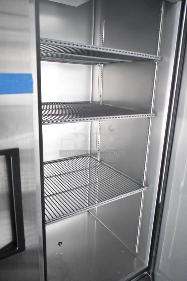 Interior view of commercial-grade cooler in retail trailer, featuring adjustable wire shelves, stainless steel construction, and clean finish.