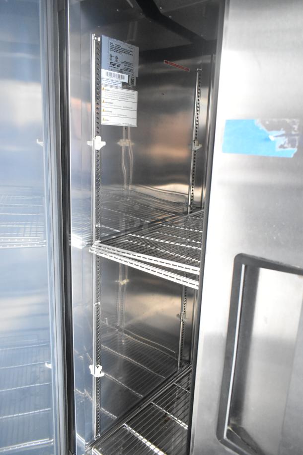 Inside view of Turbo Air Cooler in new unbranded retail trailer, showcasing stainless steel shelves and interior.
