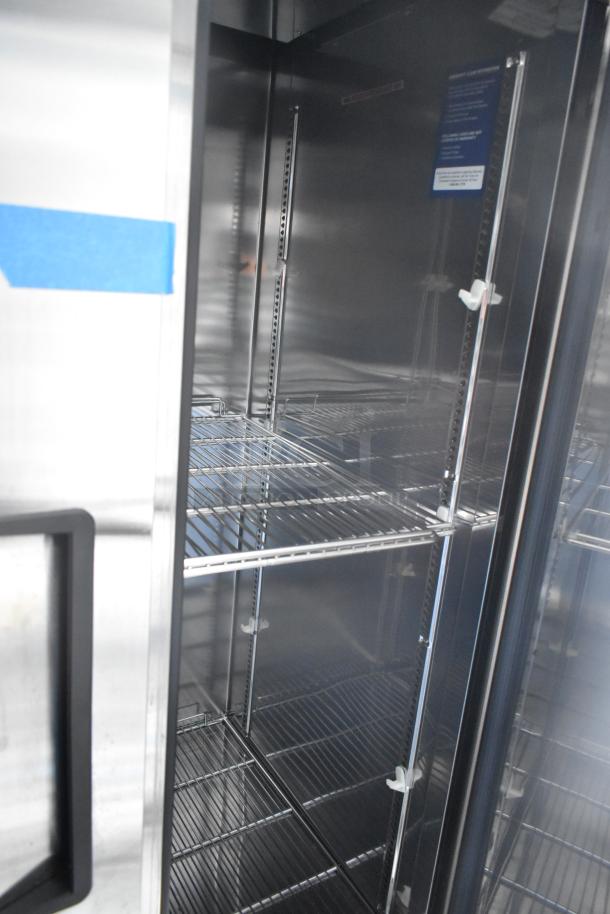 Interior view of a commercial-grade Turbo Air Cooler with wire shelving, part of a fully outfitted 2021 retail trailer.