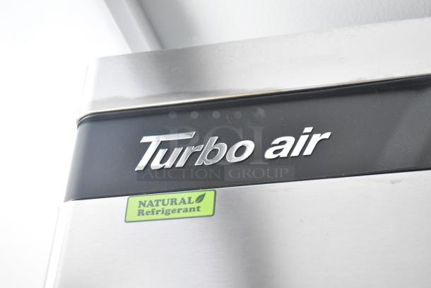 Turbo Air cooler in commercial trailer with "Natural Refrigerant" label, part of a fully equipped retail setup.