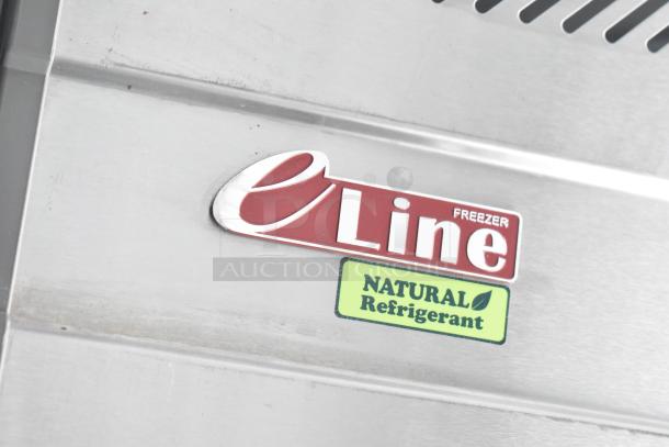 eLine Freezer label with "NATURAL Refrigerant" marking on stainless steel surface of unbranded outfitted trailer.