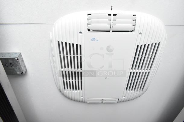 Trailer interior showing a ceiling-mounted air conditioning unit with labeled serial number "BELAIR 3000."