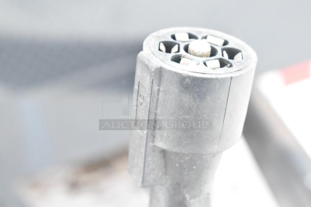 Close-up of a trailer connector plug for the 2021 unbranded cold food and beverage trailer, featuring wiring ports.