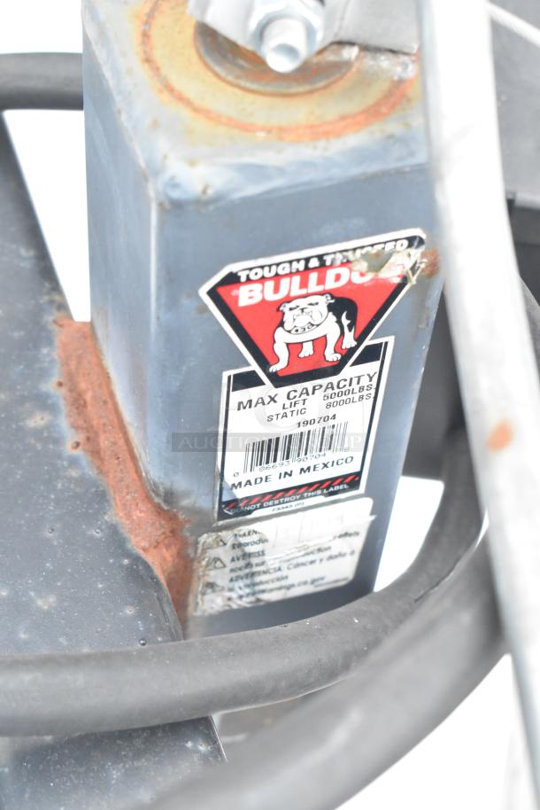 Bulldog label on trailer hitch shows max capacity: lift 5000 lbs, static 8000 lbs, made in Mexico. Rust is visible.
