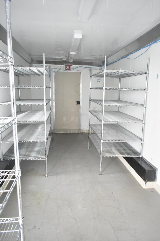 Nationwide 24' shell food trailer interior with metal shelving, Gree AC, sinks, and infrastructure. Ready for kitchen build-out.