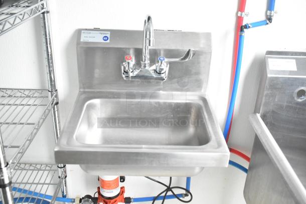 Stainless steel sink in 2021 Nationwide 24' shell food trailer, featuring hot and cold faucets and NSF certification label.