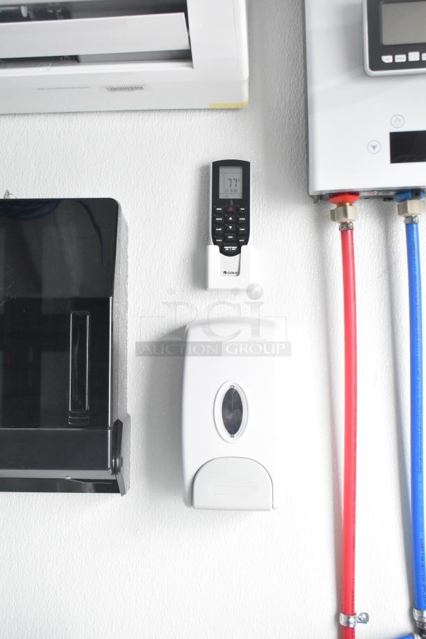 Interior view of Nationwide 24' shell food trailer featuring Gree air conditioning controls, dispenser, and part of the infrastructure setup.