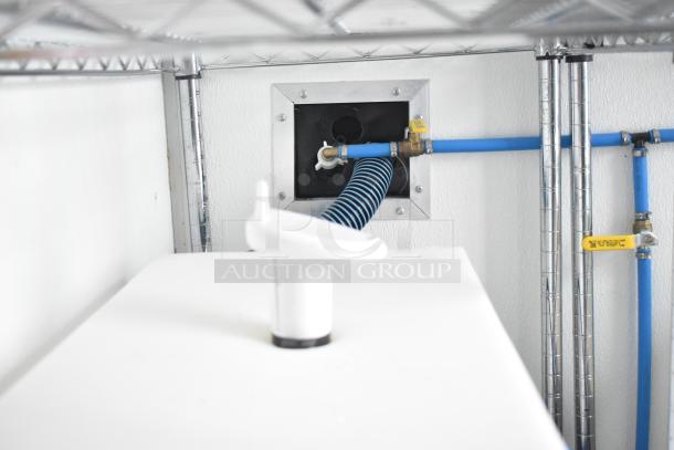 Interior of a Nationwide 24' shell food trailer showing plumbing fixtures and piping, ready for custom kitchen installation.