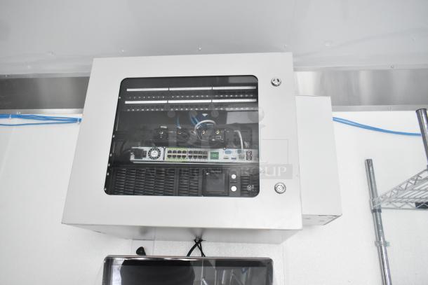 Interior view of Nationwide 24' shell food trailer showing network equipment and shelving. Ready for custom mobile kitchen build.