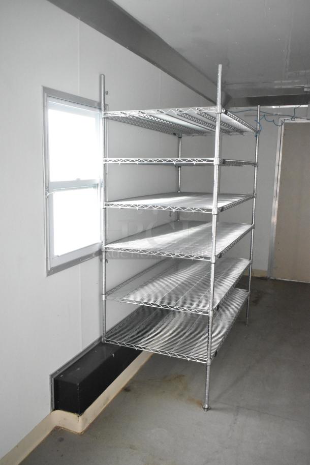 Nationwide 24' shell food trailer interior with metal shelving, window, and air conditioning infrastructure, ready for customization.