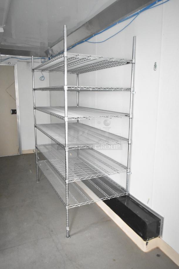 Brand new 2021 Nationwide 24' shell food trailer interior with metal shelving, ready for custom kitchen build-out. Includes Gree AC.