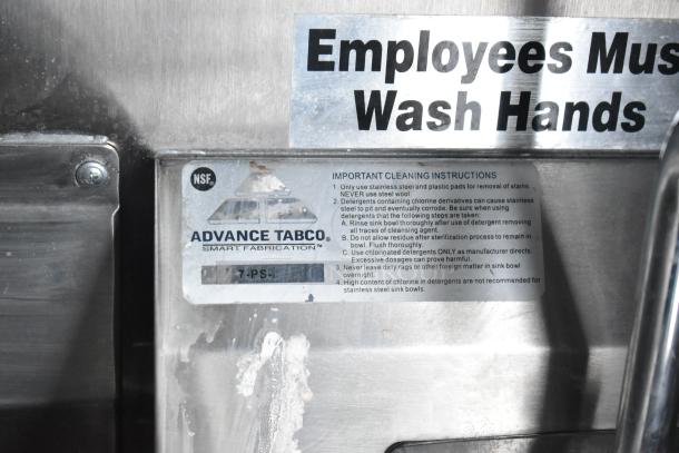"Advance Tabco cleaning instructions and NSF logo on stainless steel surface with 'Employees Must Wash Hands' sign in food trailer."