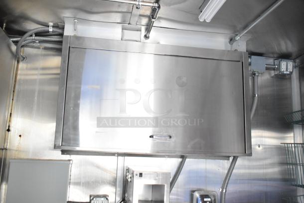 Titanium Cargo 28' shell food trailer interior showing stainless steel hood, electrical outlets, and integrated shelving.