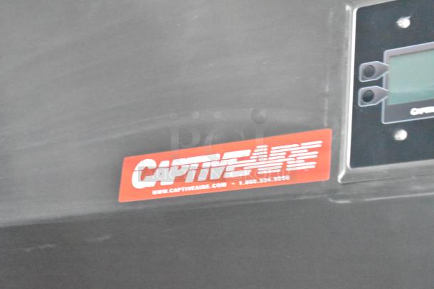 Alt text: 

Close-up of a CaptiveAire label on a Titanium Cargo 28' shell food trailer kitchen hood.