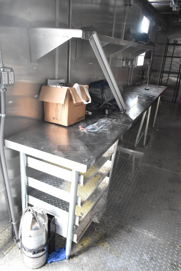Brand new 2021 Titanium Cargo 28' food trailer interior. Features grease hood, shelving, sinks, and workspace. Clear title.