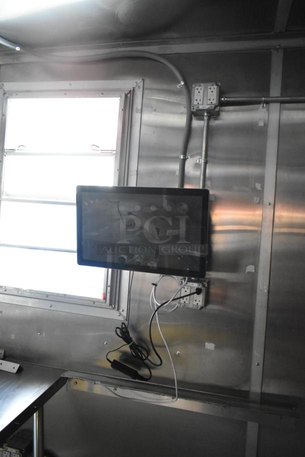 2021 Titanium Cargo 28' food trailer interior with electrical outlets, stainless steel walls, and integrated security system.