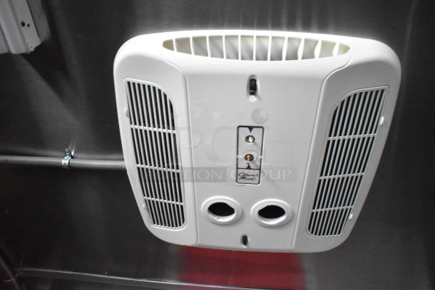 Ventilation system inside the 28' Titanium Cargo food trailer. Features integrated security, grease hood, sinks, and shelving.