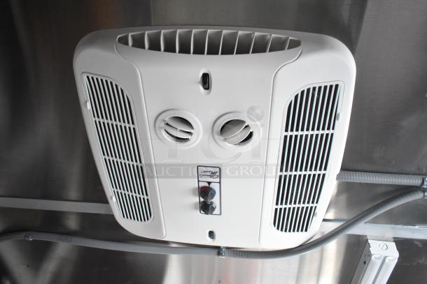 Alt text: White ceiling-mounted air vent system inside 28' Titanium Cargo food trailer.