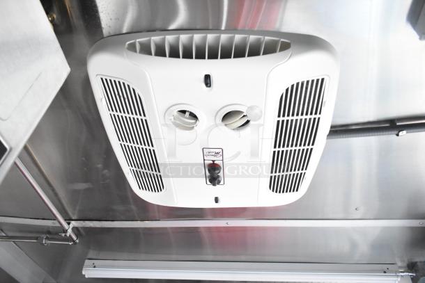 Ceiling air vent in a 2021 Titanium Cargo 28' food trailer, featuring integrated security system and stainless steel interior.