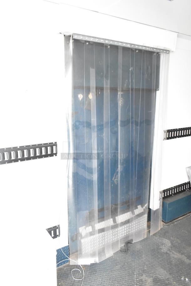 2020 Southern Dimensions 8.5' x 24' mobile walk-in cooler trailer interior with clear strip door and textured floor.