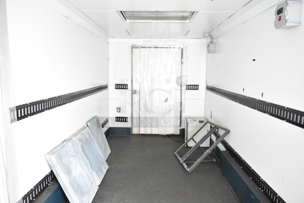 2020 Southern Dimensions 8.5' x 24' insulated mobile cooler trailer interior, with shelving units and insulated panels.