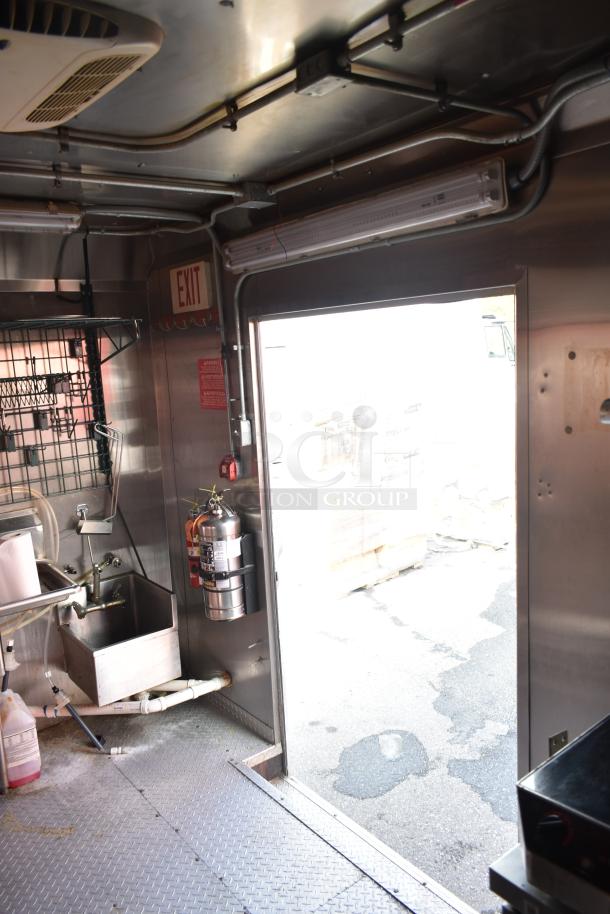 2020 Continental Cargo 8.5' x 28' enclosed mobile kitchen interior, features stainless sink, fire extinguisher, and exit sign.