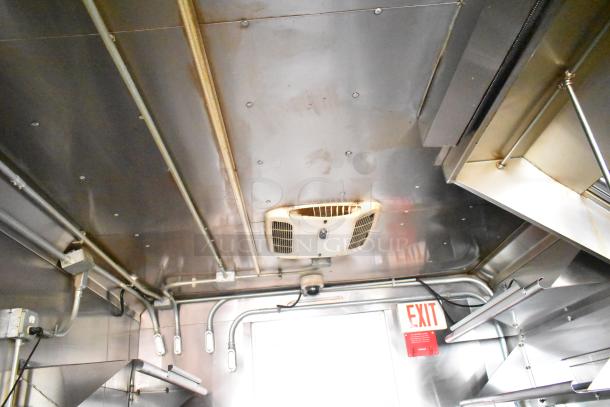 Interior of a 2020 Continental Cargo 8.5' x 28' mobile kitchen trailer showing ceiling with HVAC, pipe fittings, and exit sign.