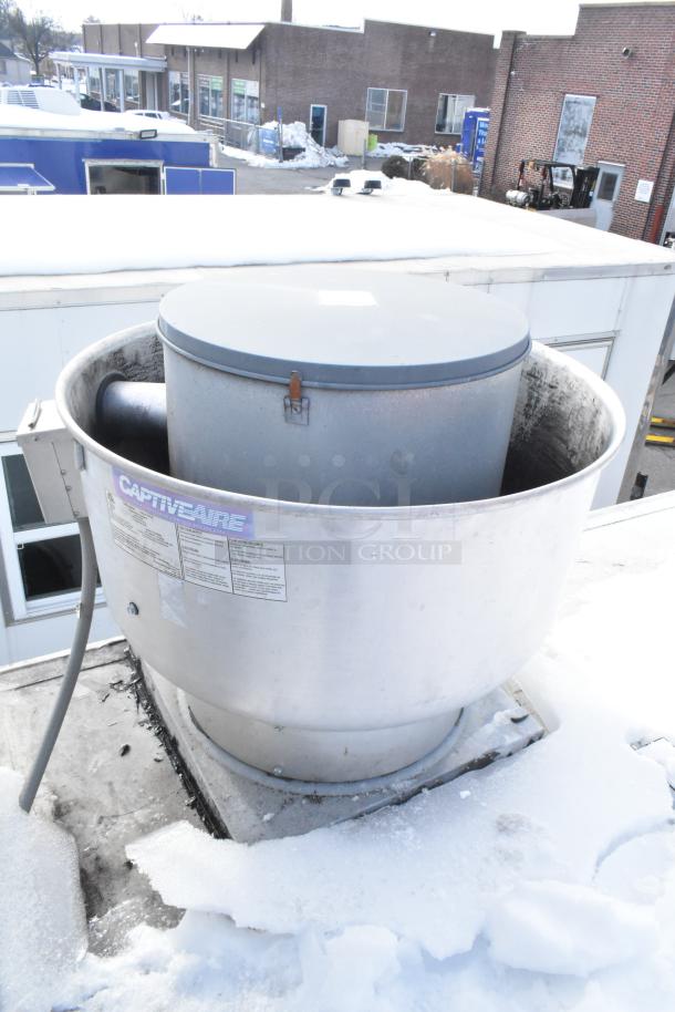 CaptiveAire exhaust fan on mobile kitchen trailer roof, used condition. Visible label with model details and vent attachments.