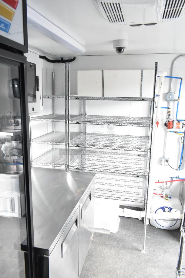 2021 Southern Dimensions 8.5' x 24' mobile refrigeration trailer interior with clean stainless steel surfaces, shelving, and plumbing.