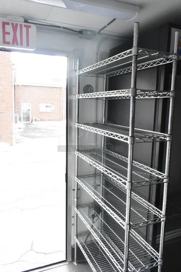 Interior view of 2021 Southern Dimensions refrigerated trailer, featuring metal shelving and clean, lightly used condition.