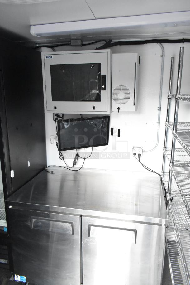 2021 Southern Dimensions 8.5' x 24' enclosed trailer interior, featuring stainless surfaces, shelves, and cooling units; excellent condition.