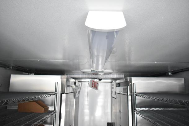 Interior view of a 2021 Southern Dimensions 8.5' x 24' cold food trailer, featuring stainless steel shelving, commercial coolers, and an exit sign.