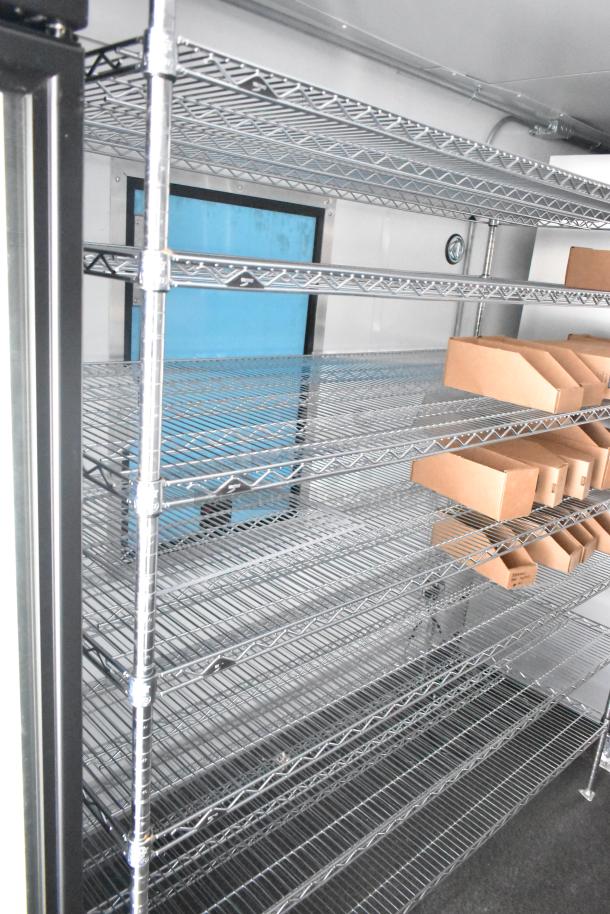 Interior of 2021 Southern Dimensions 8.5' x 24' cold food trailer with wire shelving, in excellent condition.
