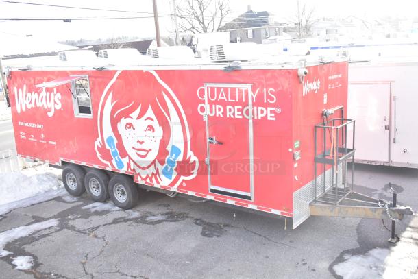 2021 Titanium Cargo 8.5' x 28' mobile kitchen trailer, red Wendy's branding, triple axle, equipped with plumbing and electric.