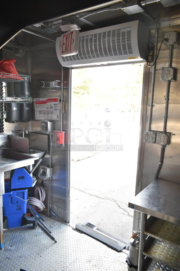 2021 Titanium Cargo 8.5' x 28' mobile kitchen trailer interior; shows entry, sink, shelving, and utilities.