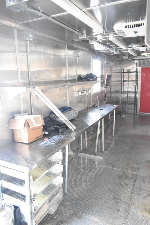 2021 Titanium Cargo 8.5' x 28' mobile kitchen trailer interior; features grease hood, plumbing, HVAC, and utility connections.