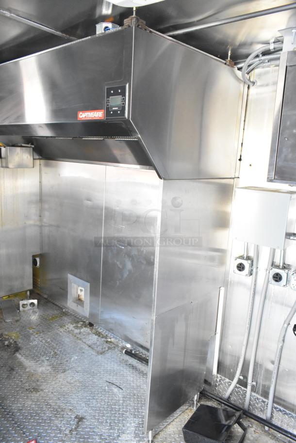2021 Titanium Cargo mobile kitchen trailer interior with CaptiveAire 7'7" grease hood, plumbing, and 3-phase electric outlets shown.