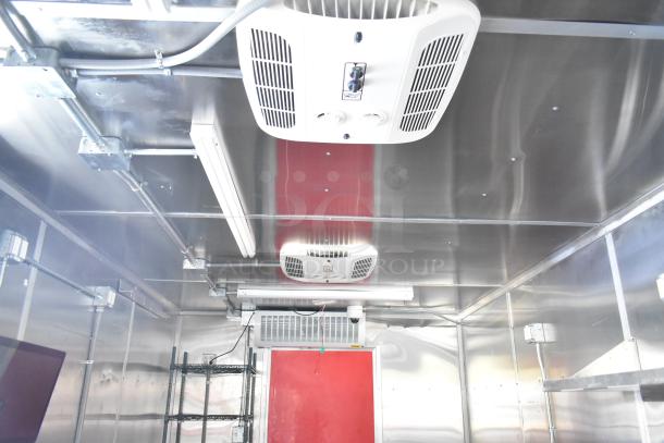 2021 Titanium Cargo 8.5' x 28' mobile kitchen trailer interior, featuring a CaptiveAire 7'7" grease hood, Coleman Mach A/C, and full plumbing infrastructure. Triple axle, previously a Wendy's ghost kitchen.