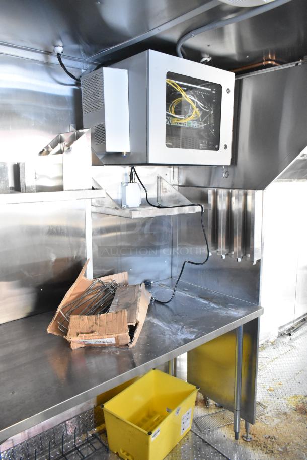 2021 Titanium Cargo 8.5' x 28' mobile kitchen trailer with CaptiveAire hood, 3-phase electric, plumbing, and IT cabinet.