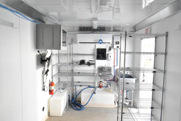 2021 Diamond Cargo 8.5'x24' trailer interior; climate-controlled, Gree HVAC, 48-port network, hand wash sink, Metro shelving.