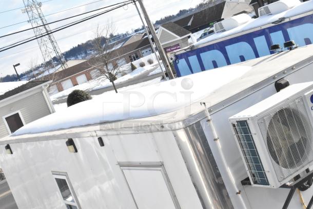 2021 Diamond Cargo 8.5' x 24' trailer with Gree Mini-Split HVAC, for climate-controlled mobile storage, shown in snowy setting.