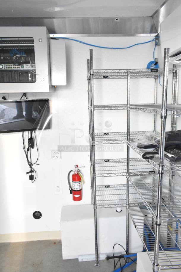 2021 Diamond Cargo mobile storage trailer interior with metro shelving, IT network equipment, and fire extinguisher.
