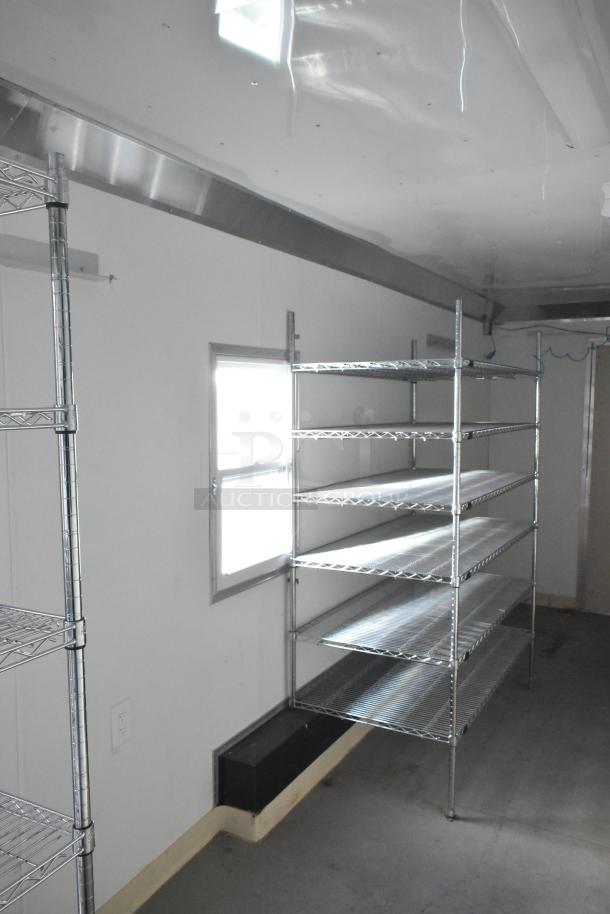 2021 Diamond Cargo 8.5' x 24' trailer interior with metal Metro Shelving, Gree Mini-Split HVAC, and hand wash sink.